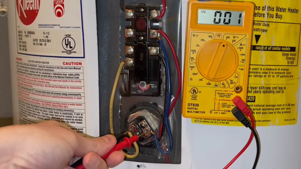 Meter and test leads at an electric water heater access panel